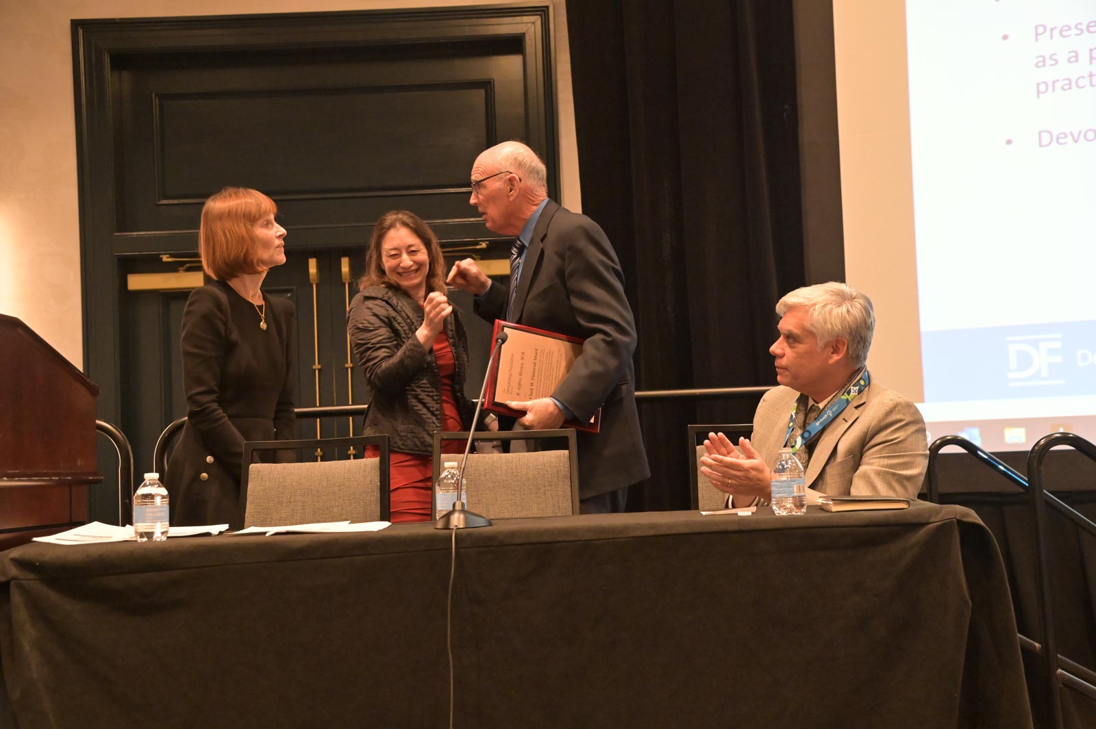 <em>From left:</em> Dr. Janet Fairley, Dr. Kristen Kelly and Clark W. Finnerud Award recipient Dr. R. Jeffrey Herten, and DF Executive Director John Bournas.