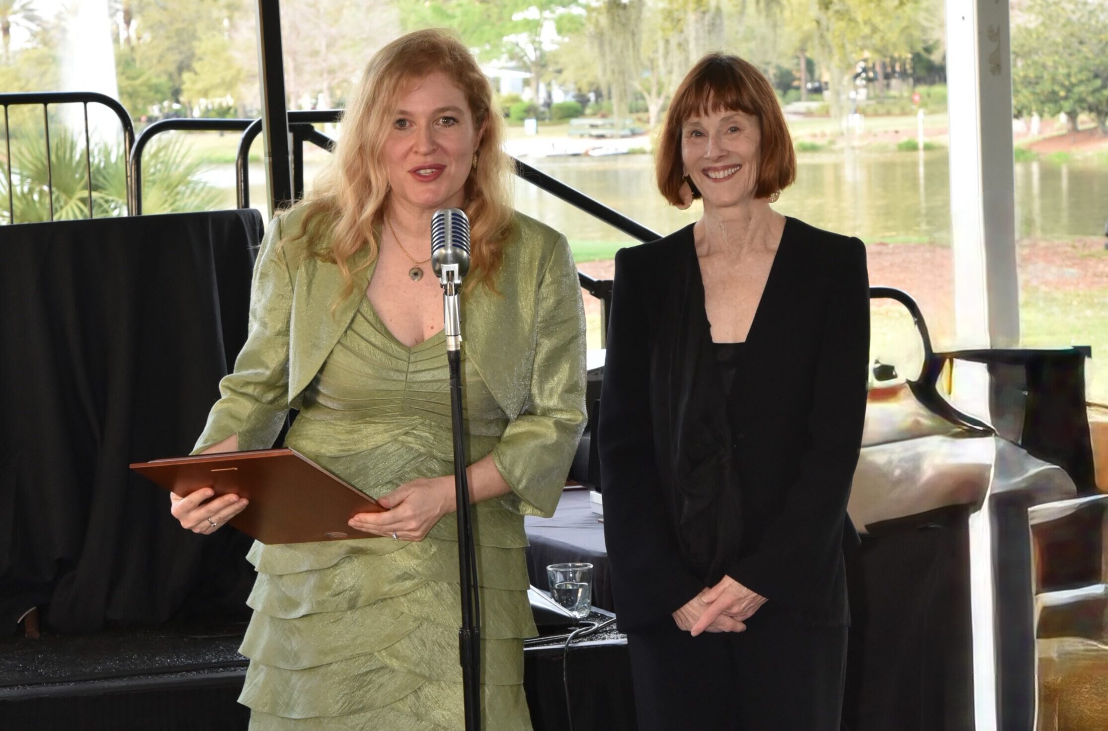 Two women standing on stage
