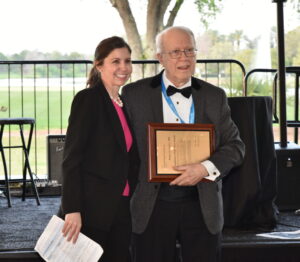 Woman and man smiling on a podium