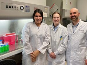 Two female and one male doctor in white lab coats.